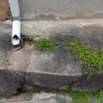 How Gutter Problems Trigger Cracks in Foundations and Walkways